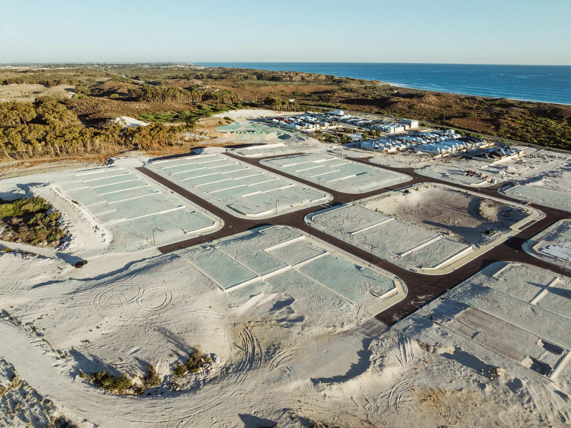 Coastal land subdivision with prepared lots and the ocean beyond