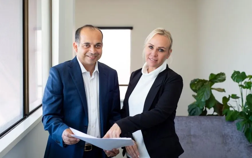 Real IQ directors holding property plans in their office